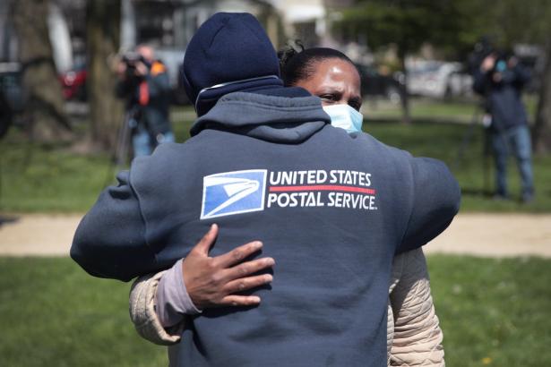 Annette Clay gets a hug from a postal worker during a ceremony honoring her daughter Unique Clay. 
