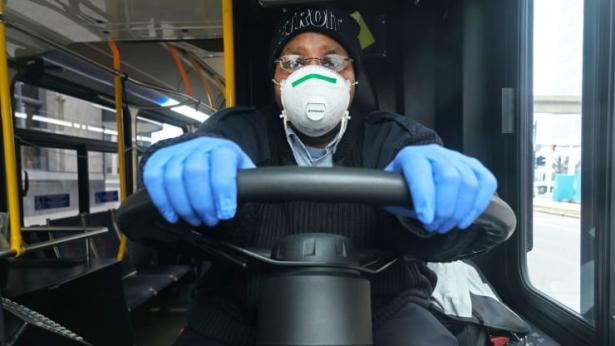 bus driver waering mask and gloves